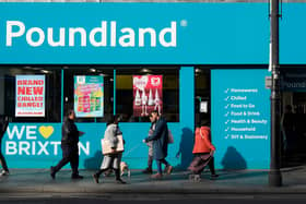 Shoppers walk past a Poundland shop in Brixton, south London.