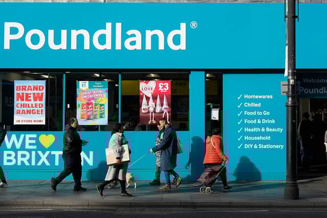 Shoppers walk past a Poundland shop in Brixton, south London.