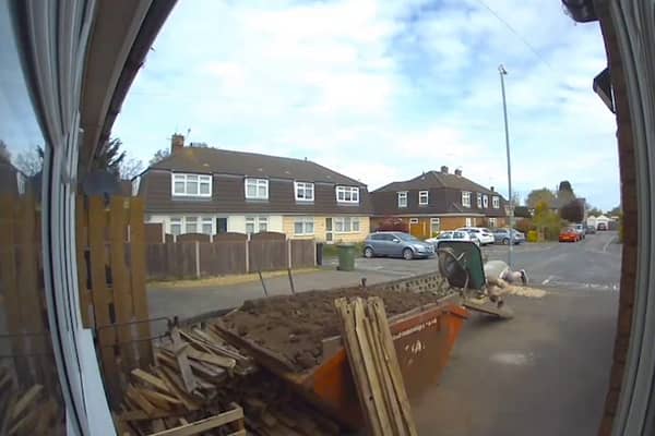 Man covers himself in soil after wheelbarrow tips over.