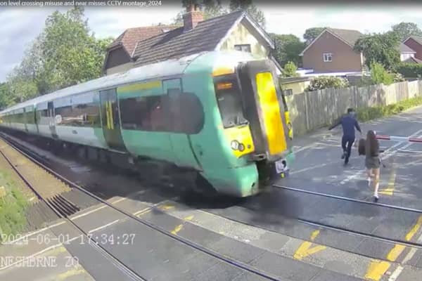 Shocking CCTV films the moment a girl risks her life at a level crossing, walking just a couples of metres in front of an advancing train.