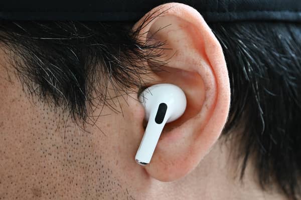 A customer wears an Apple AirPod. Photo: Patrick T. Fallon / AFP via Getty Images