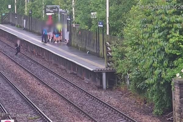 A child jumping onto the tracks in front of a train. 