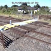 Toddler steps onto Sandy Lane level crossing in Prestatyn, North Wales.