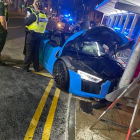 A light blue Audi R8 supercar hit a street post. 