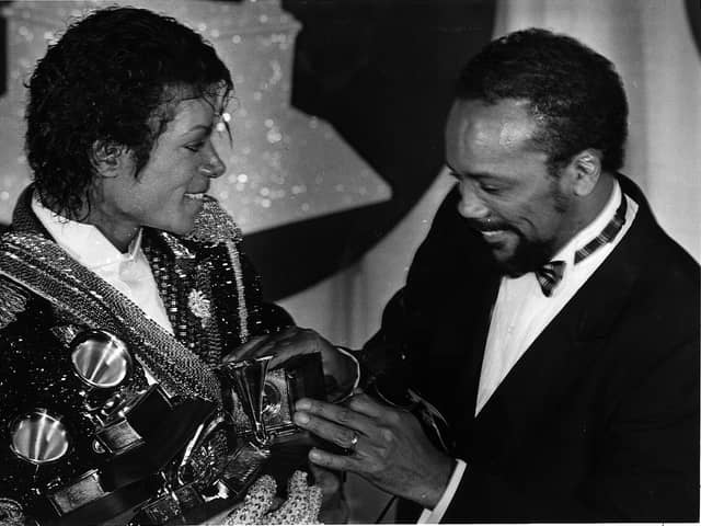 Michael Jackson, left, with Quincy Jones with armful of Grammys at the award show Feb. 28, 1984