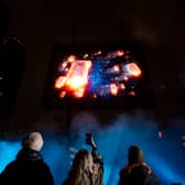 Visuals of a blue whale, northern lights, and football tricks are displayed in a hologram show over London