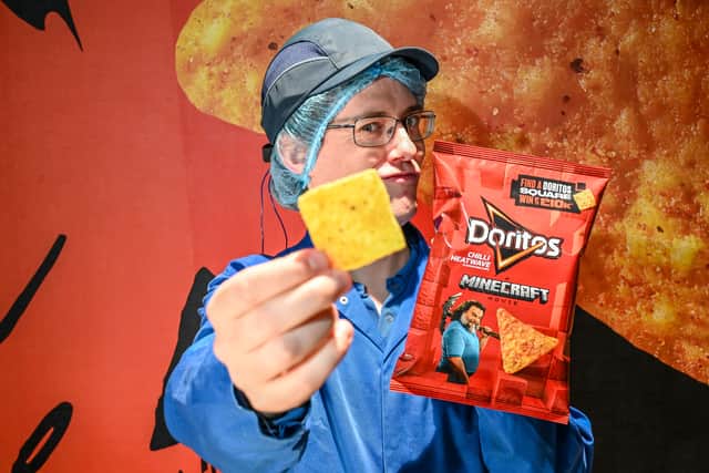 Chief Chip Technician Dan Lynes inspects the world's first square Doritos