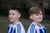 Flo Topham (L) and Camille Porhel, who play for York Railway Institute (YRI) AFC u12s Girls, have launched a campaign defending their right to have short hair, after they were accused of being boys during a game. 