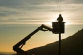 A BT worker fixs telephone lines (Photo: Ashley Cooper/Construction Photography/Avalon/Getty Images)