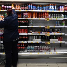An employee stocks shelves at a Tesco supermarket in central London in 2021 (Photo: JUSTIN TALLIS/AFP via Getty Images)