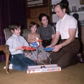 British boxer Henry Cooper plays the game frustration, at home with his family, in 1971