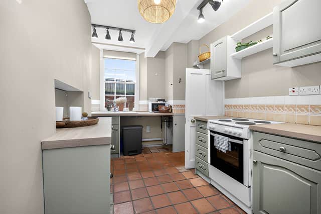 The property's kitchen forms part of the traditional three-storey cottage, alongside a living room and cellar