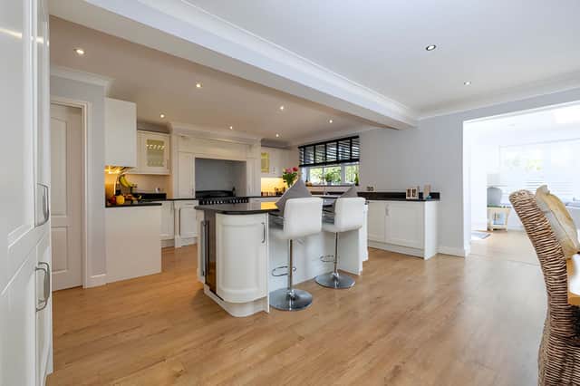A central island, granite worktops and integrated appliances make the kitchen and dining area a focal point