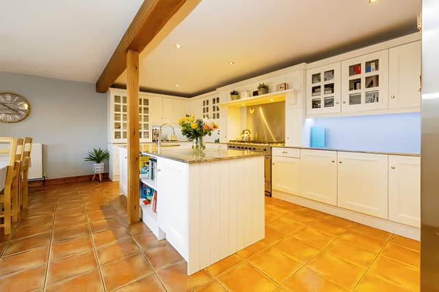 The kitchen island and adjoining dining area create a central space for family meals and entertaining