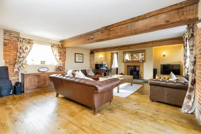 A feature fireplace and log-burning stove give the main living room a traditional focal point