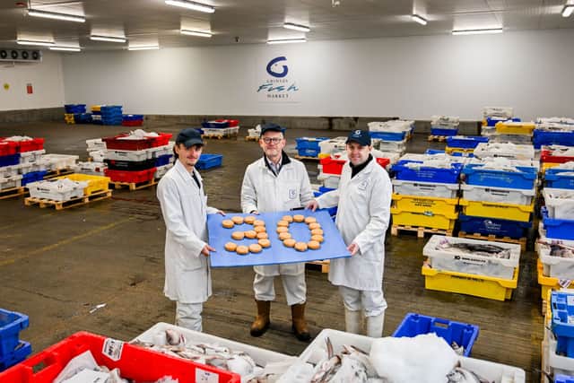 Fish cakes made with haddock sourced from the auction are used to signal 30 years of Grimsby Fish Market. Pictured are, from left, Will Gibbs, trainee fish auctioneer; Nelson Hunter, fish market sales director and Danny Payne, operations director.