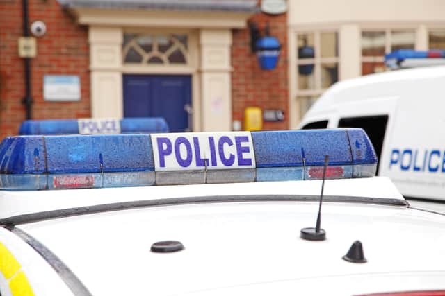 Close up of parked police vehicles outside a county police station.