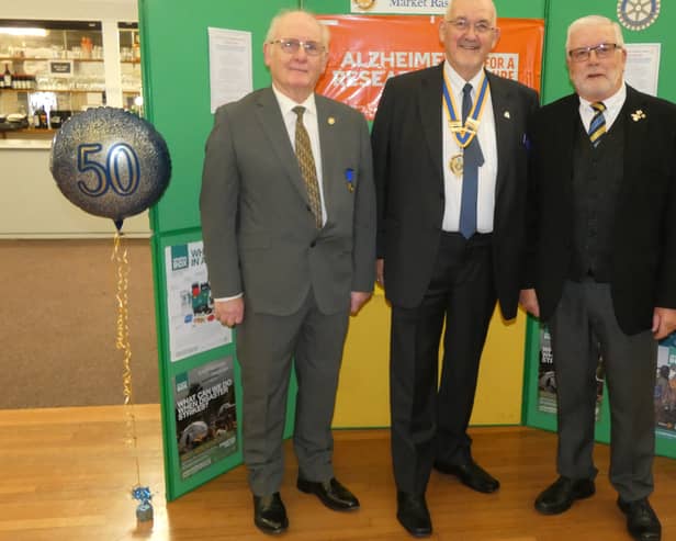 Organisers Rtns. Stuart Davies and Derek Anderson stand either side of President Malcolm Stimpson