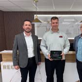 Richard Topliss of RT Autos Bodyshop receiving the award (centre) from Enterprise manager John Martin (left) Thomas Neeld (right).