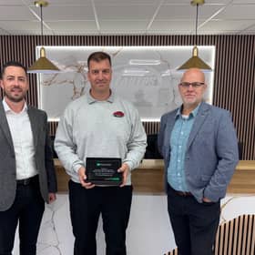 Richard Topliss of RT Autos Bodyshop receiving the award (centre) from Enterprise manager John Martin (left) Thomas Neeld (right).