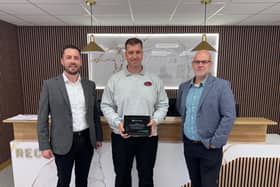 Richard Topliss of RT Autos Bodyshop receiving the award (centre) from Enterprise manager John Martin (left) Thomas Neeld (right).