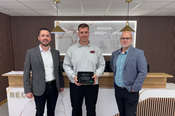 Richard Topliss of RT Autos Bodyshop receiving the award (centre) from Enterprise manager John Martin (left) Thomas Neeld (right).