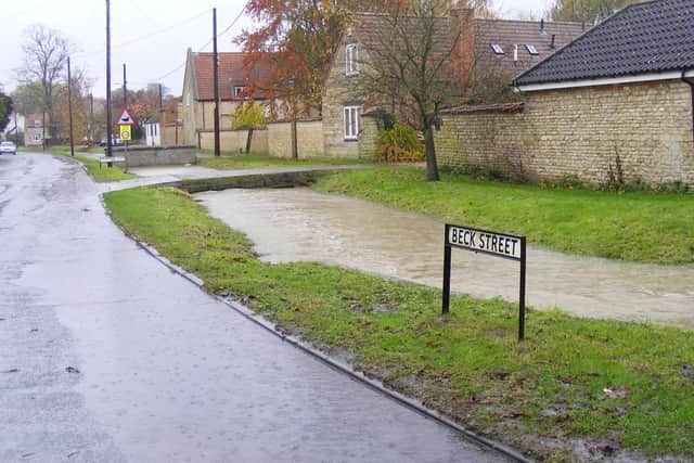 The swollen Digby Beck on the verge of overflowing into the street on Thursday morning.