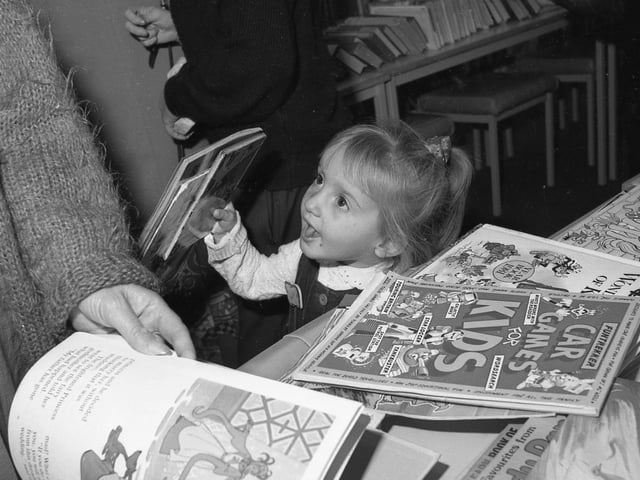Little Heidi Wharff finds a bargain among the books.