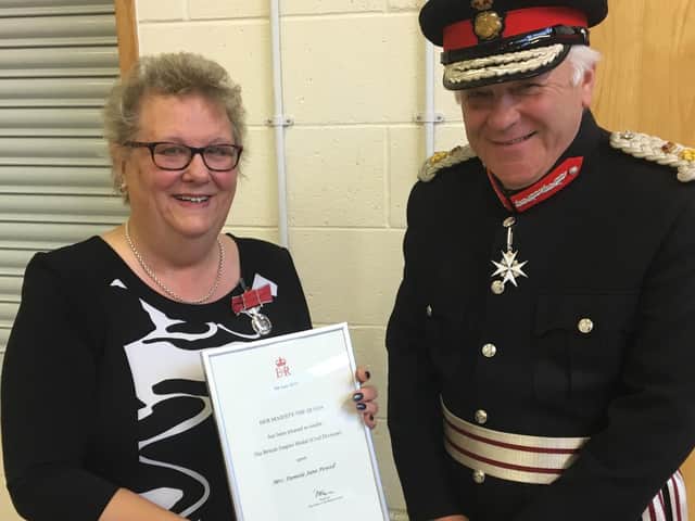 Pam Powell receives the BEM from Lord Lieutenant of Lincolnshire, Mr Toby Dennis.