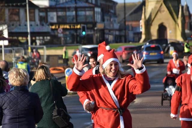 'I did it': Santas head for the finish line. Photo: Barry Robinson.