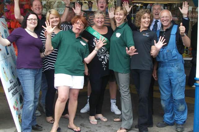 Staff raising money at a charity event. ANL-191212-090143001