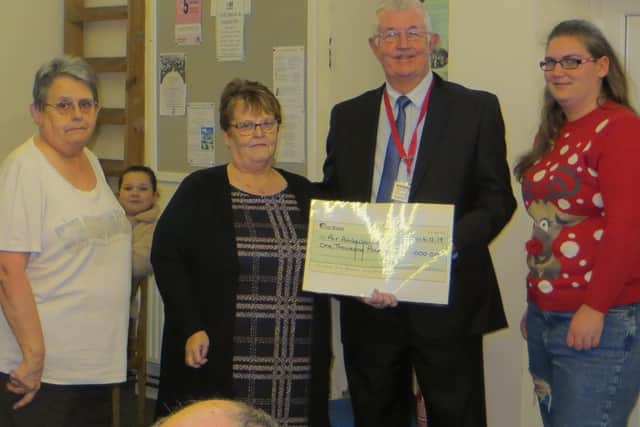 Steve Tandy, from the Lincs & Notts Air Ambulance, receiving the cheque from organiser Alison Chalmers.