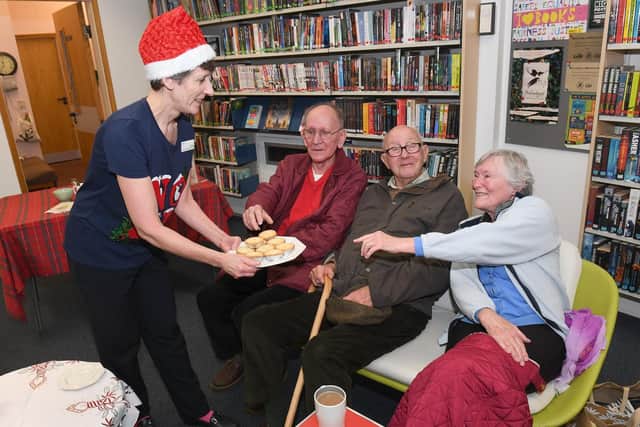 Festive Morning at Sleaford Library in aid of Cancer Research UK. Cultural Services Advisor Jane Haines offering mince pies to L-R Alan Farmer, Daniel Elmer and Sylvia Spencer. EMN-191220-132757001
