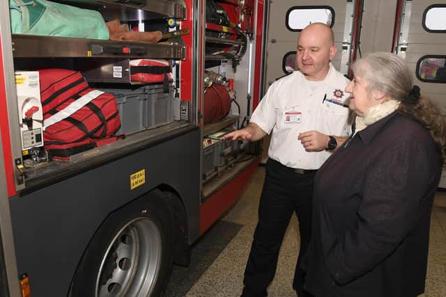 Julie Housego visits Boston fire station to thank the firefighters who rescued her from her burning house. Julie pictured with Tim Joyce