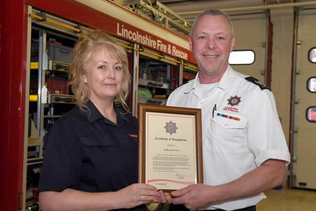 Sally is presented with her certificate by Tim
