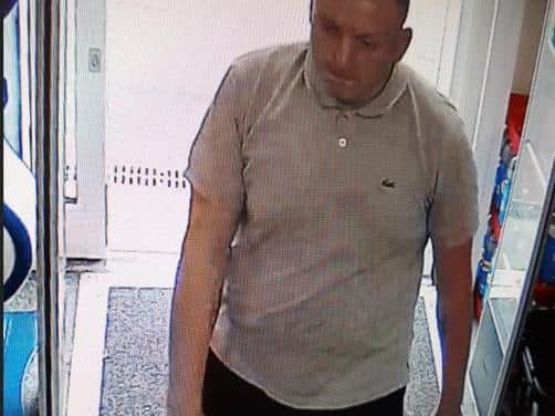 A CCTV image of a man police want to speak to in relation to fraud investigation
