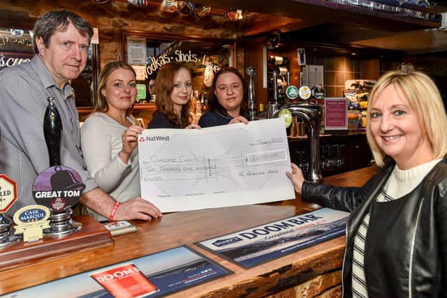 In the run up to New Year's Eve the Fortescue Arms in Billingborough held a series of events raising money for Debbie Chssum's 14th Marathon in April 2020 in aid of the Ovacome ovarian cancer charity. The total raised was £2,100. Pictured, from left - Steve Rudge - landlord, with front of house staff Lindsay Grove, Libby Sadler and Kate Crunkhorn, with Debbie Chessum. EMN-200120-145324001