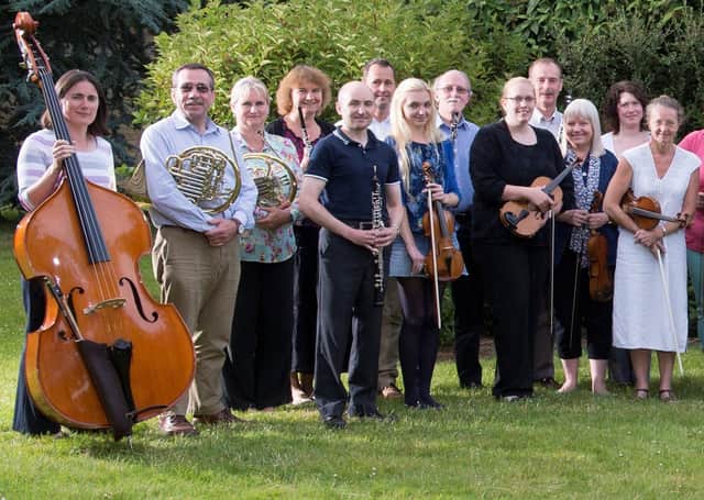 Some of the orchestra with their conductor for the concert Roderick Dunk. EMN-200131-172817001