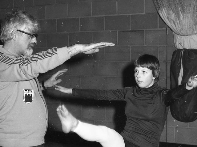 Tina French tries a few high kicks, helped by coach Roger Campling.