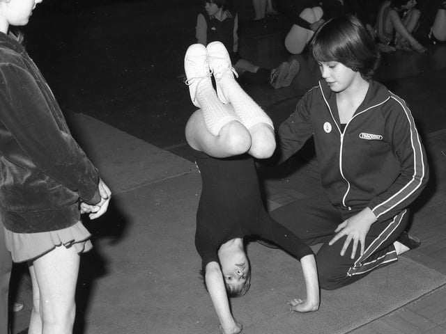 Debbie Goodliffe (far right) gives a little help to Clare Sergeant and her head-stand.