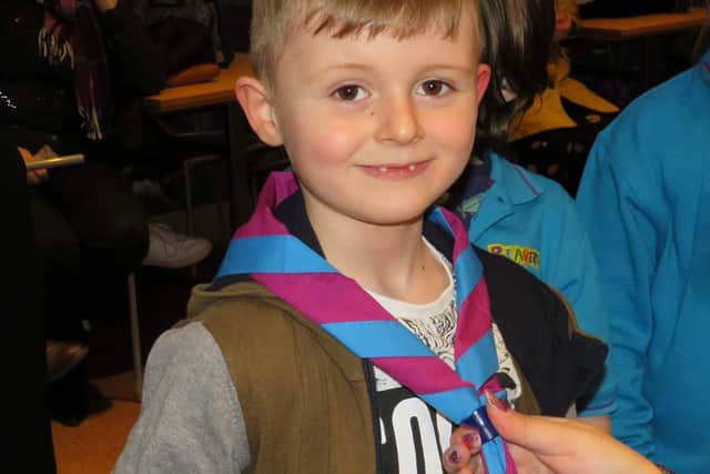 A proud Rowan is invested at 1st Wainfleet Scouts at a ceremony at the Lincolnshire Wildlife Park.