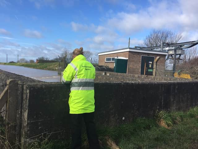 A member of East Lindsey District Council staff inspecting a pumping station near Wainfleet.