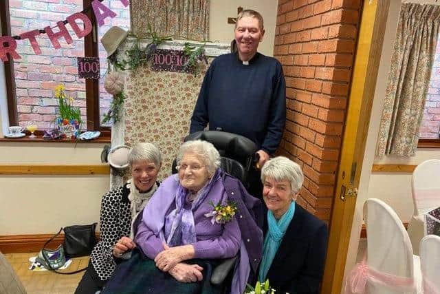 Joan pictured with her children on her 100th birthday