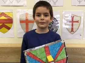 Daniel Harris holds his recycled shield which bears a message of peace. EMN-200227-172849001