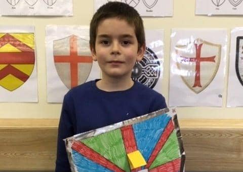 Daniel Harris holds his recycled shield which bears a message of peace. EMN-200227-172849001