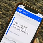 Department of Health and Social Care handout photo of of the NHS contact tracing app on a mobile phone. Photo: PA