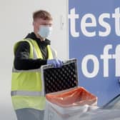 A worker at a Covid-19 driving in testing centre at Temple Green Park and Ride in Leeds, West Yorkshire. Photo: PA