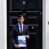 Chancellor of the Exchequer Rishi Sunak holds a copy of his Winter Economy Plan outside No 11 Downing Street before heading for the House of Commons to give MPs details of his Winter Economy Plan. Photo: PA