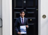 Chancellor of the Exchequer Rishi Sunak holds a copy of his Winter Economy Plan outside No 11 Downing Street before heading for the House of Commons to give MPs details of his Winter Economy Plan. Photo: PA