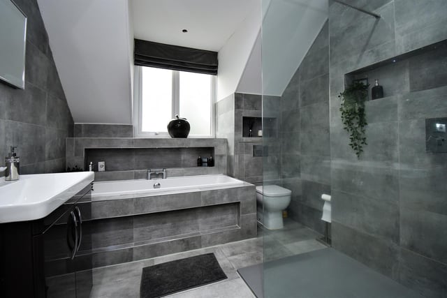 A walk in shower cubicle forms part of this impressive bathroom.